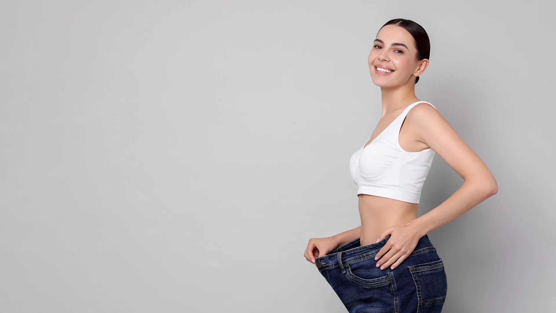 Woman celebrating weight loss results at iCRYO Helotes Medical Weight Loss program